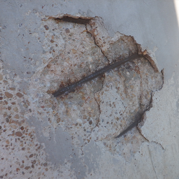 Spalling concrete, exposed rebar on silos